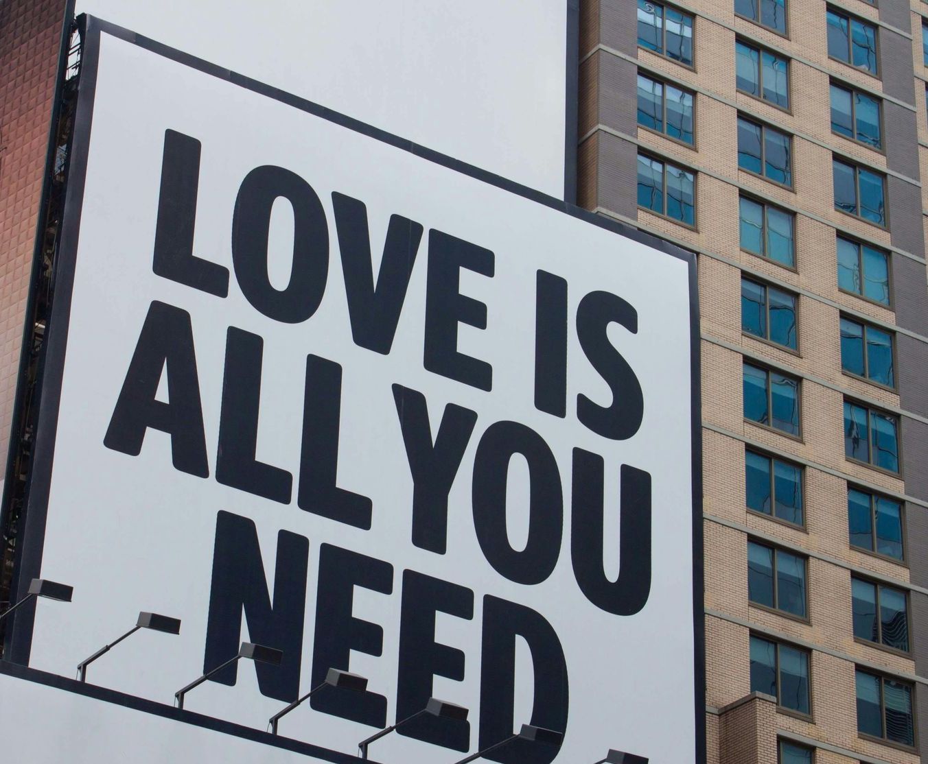 A sign on a building that says love is all you need