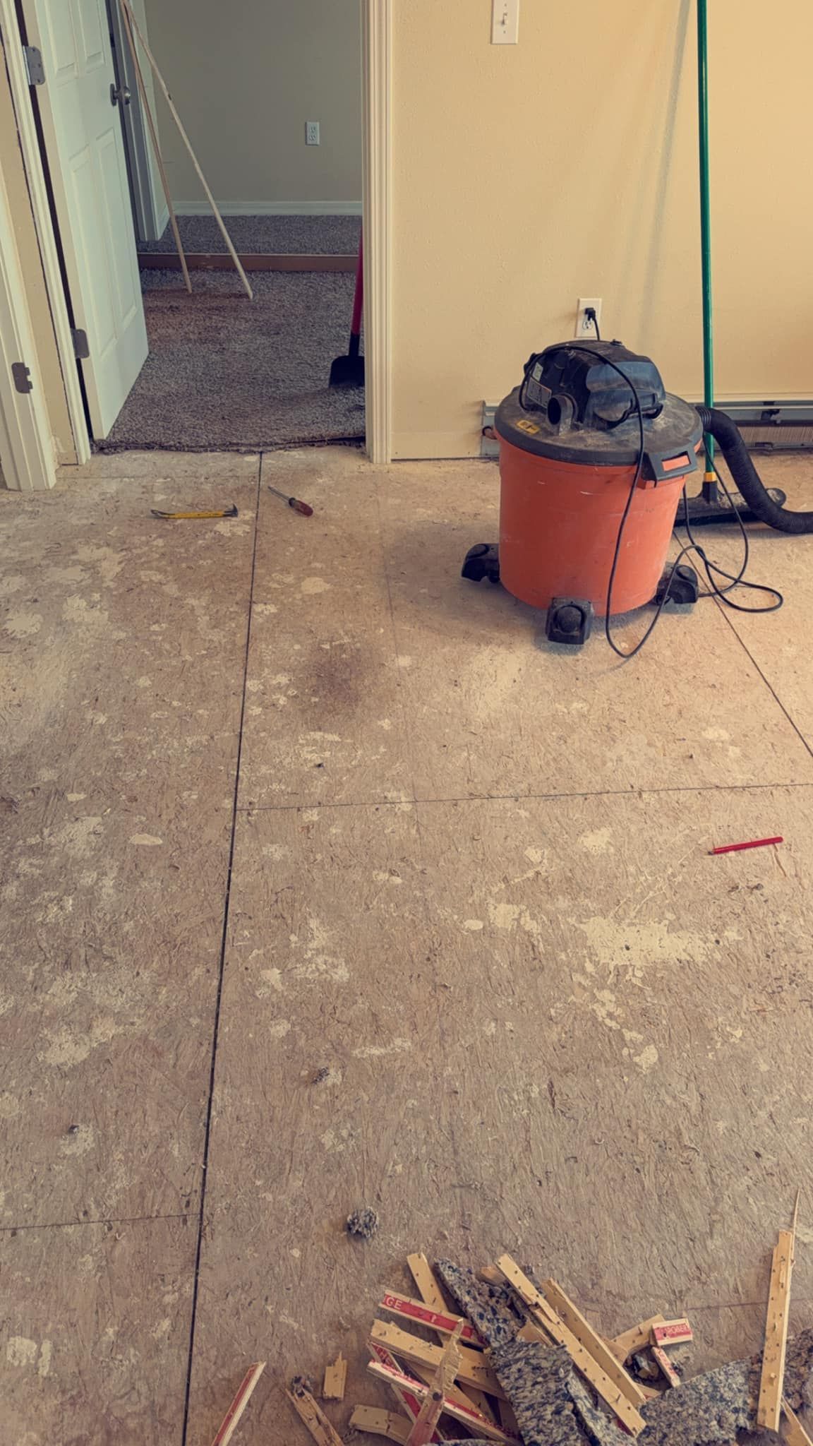 A vacuum cleaner is sitting on the floor in a room.