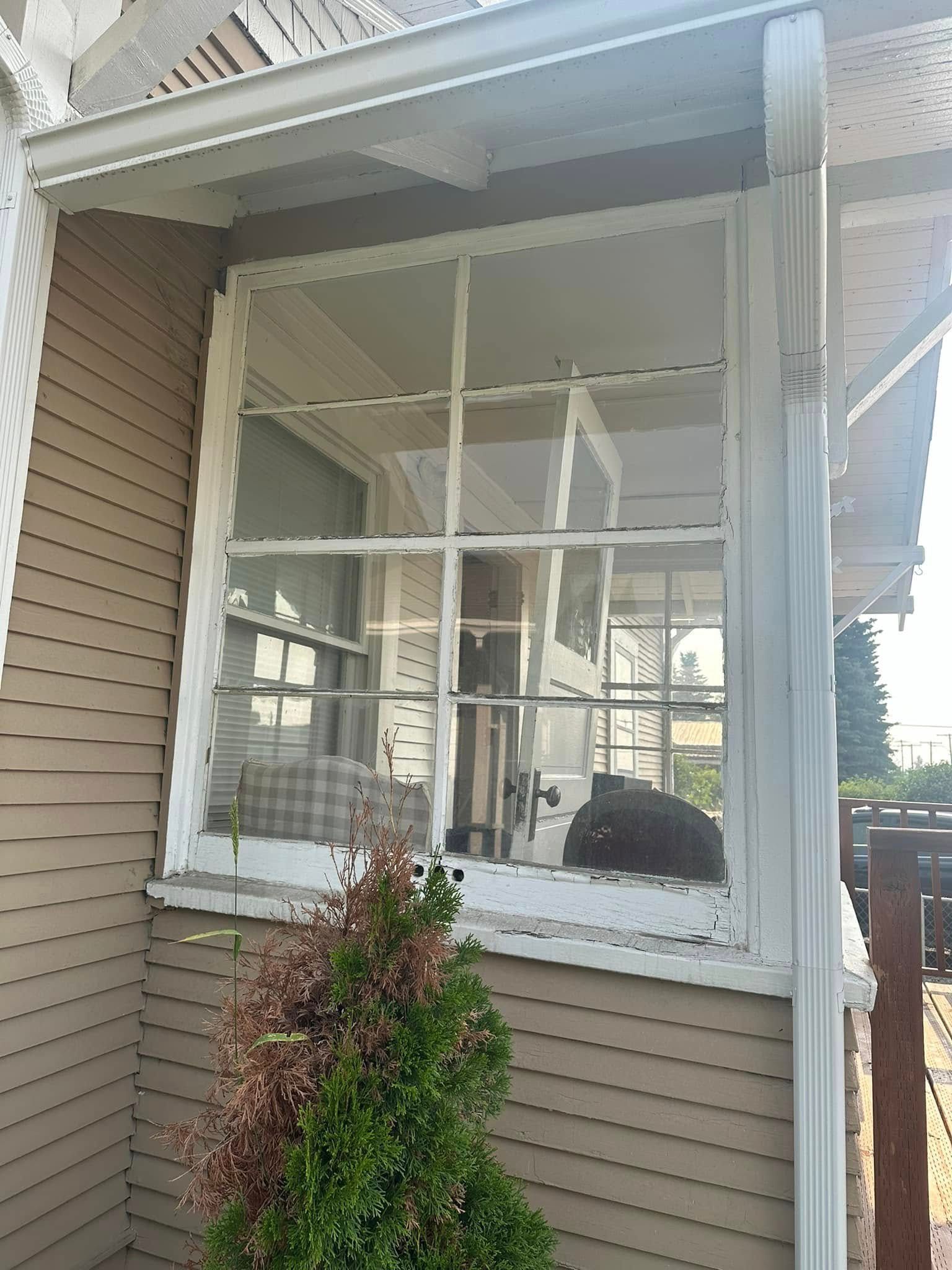 A broken window on the side of a house