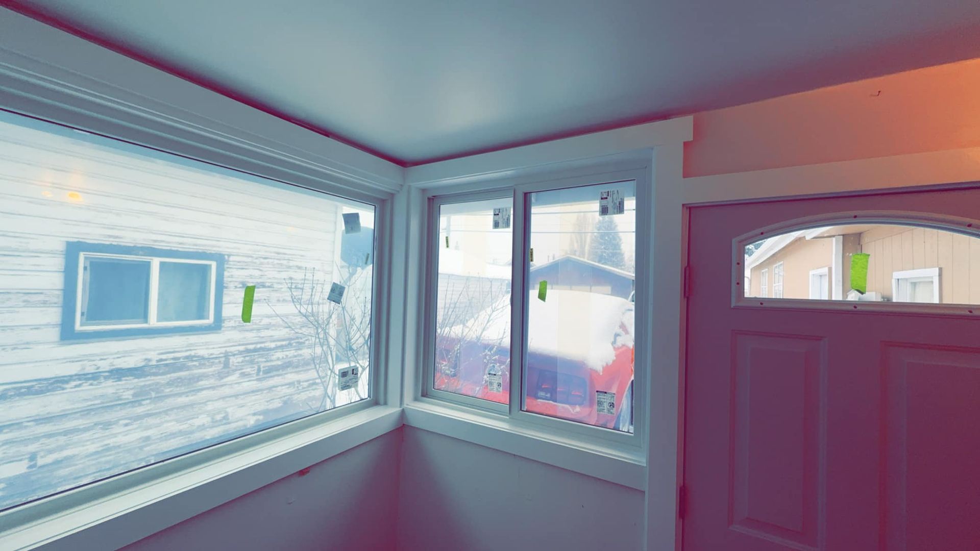 An empty room with a window and a door.