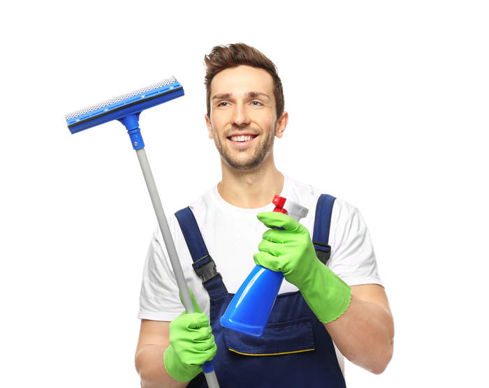 A man in green gloves is holding a mop and a spray bottle.