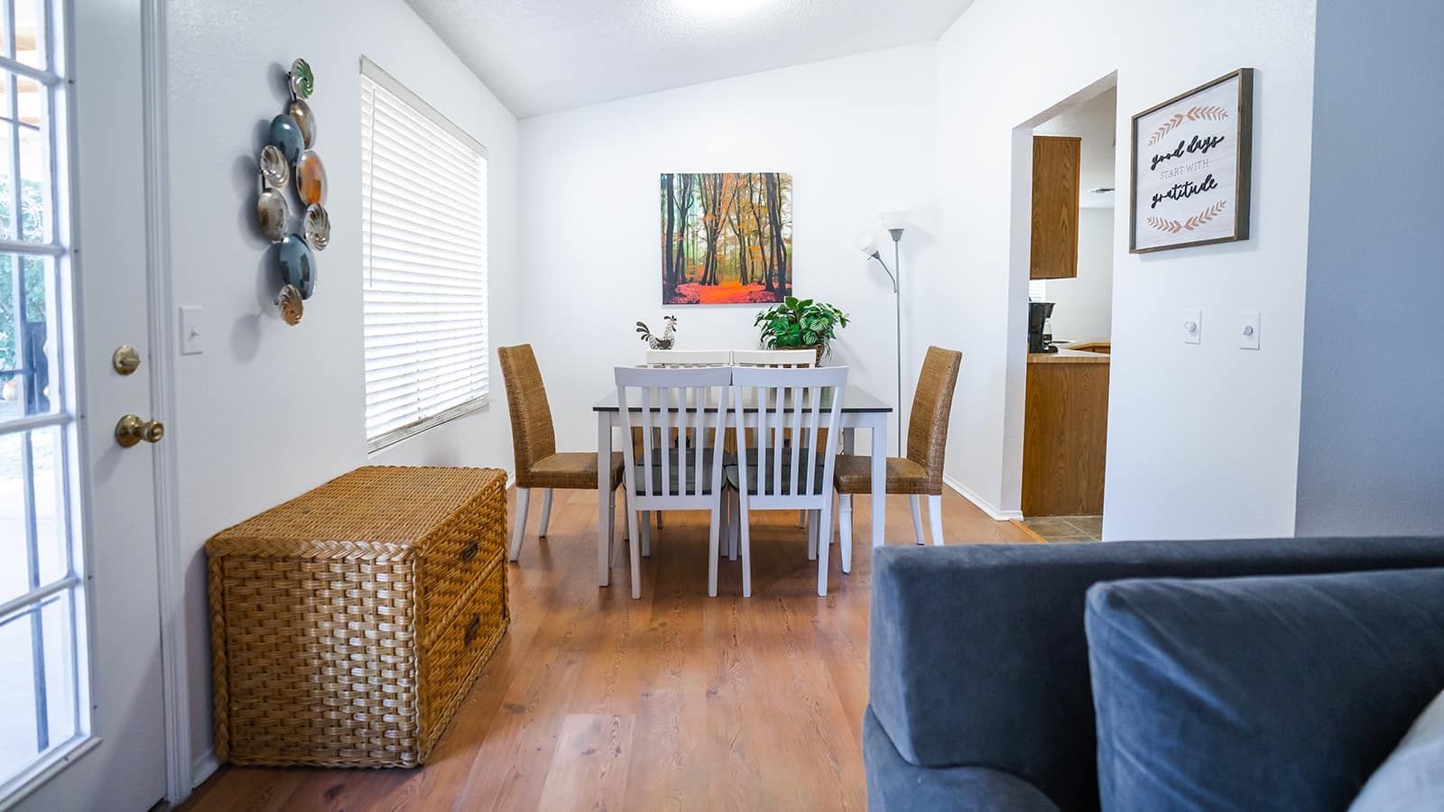 A living room with a dining table and chairs and a couch.