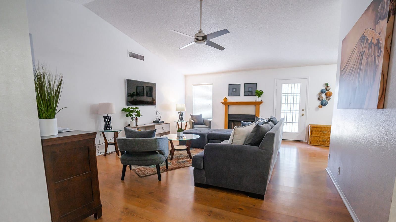 A living room filled with furniture and a ceiling fan.