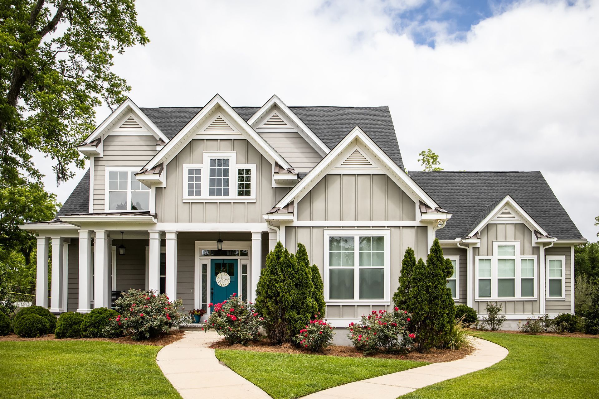 Well-designed front yard with trimmed lawns and decorative plants.