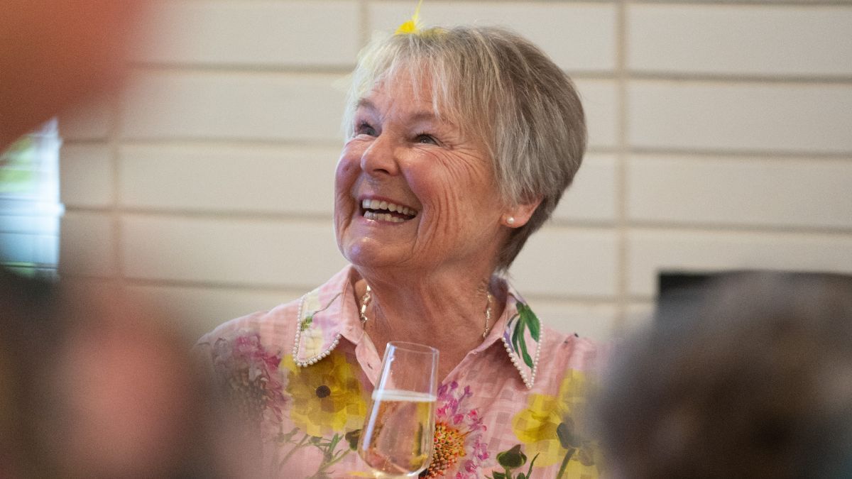 Resident smiling at village event