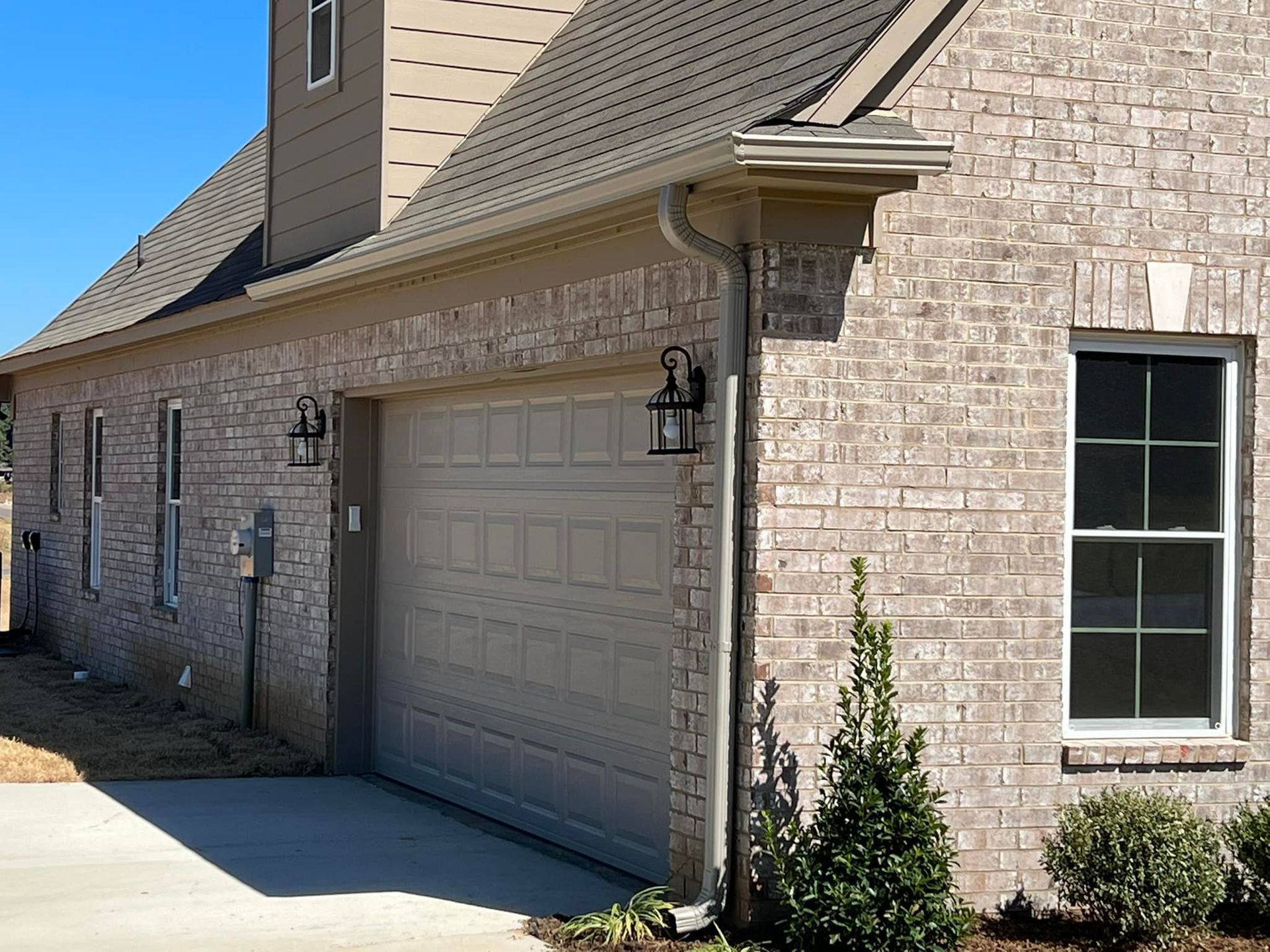 A brick house with a garage and a window