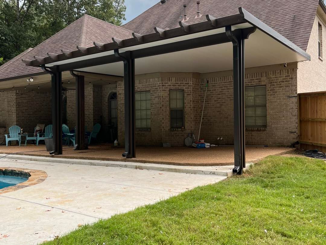 A house with a covered patio and a pool in the backyard.