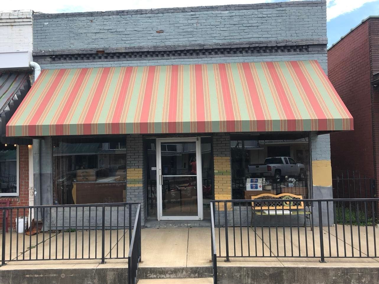 A colorful awning is covering the front of a building.