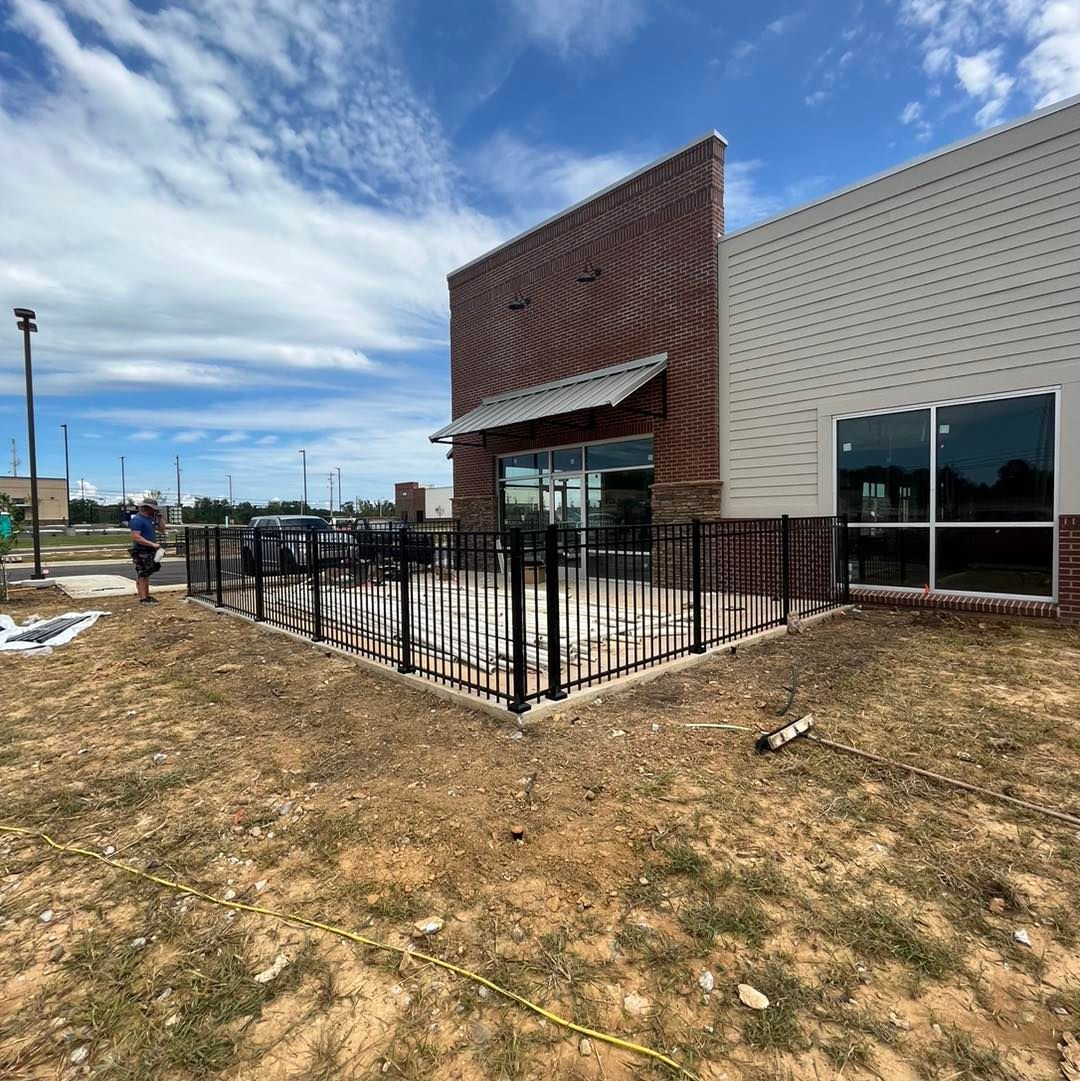A large building with a fence in front of it