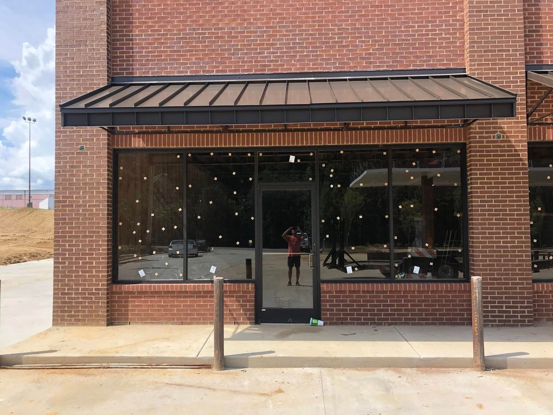 A brick building with a canopy over the front door