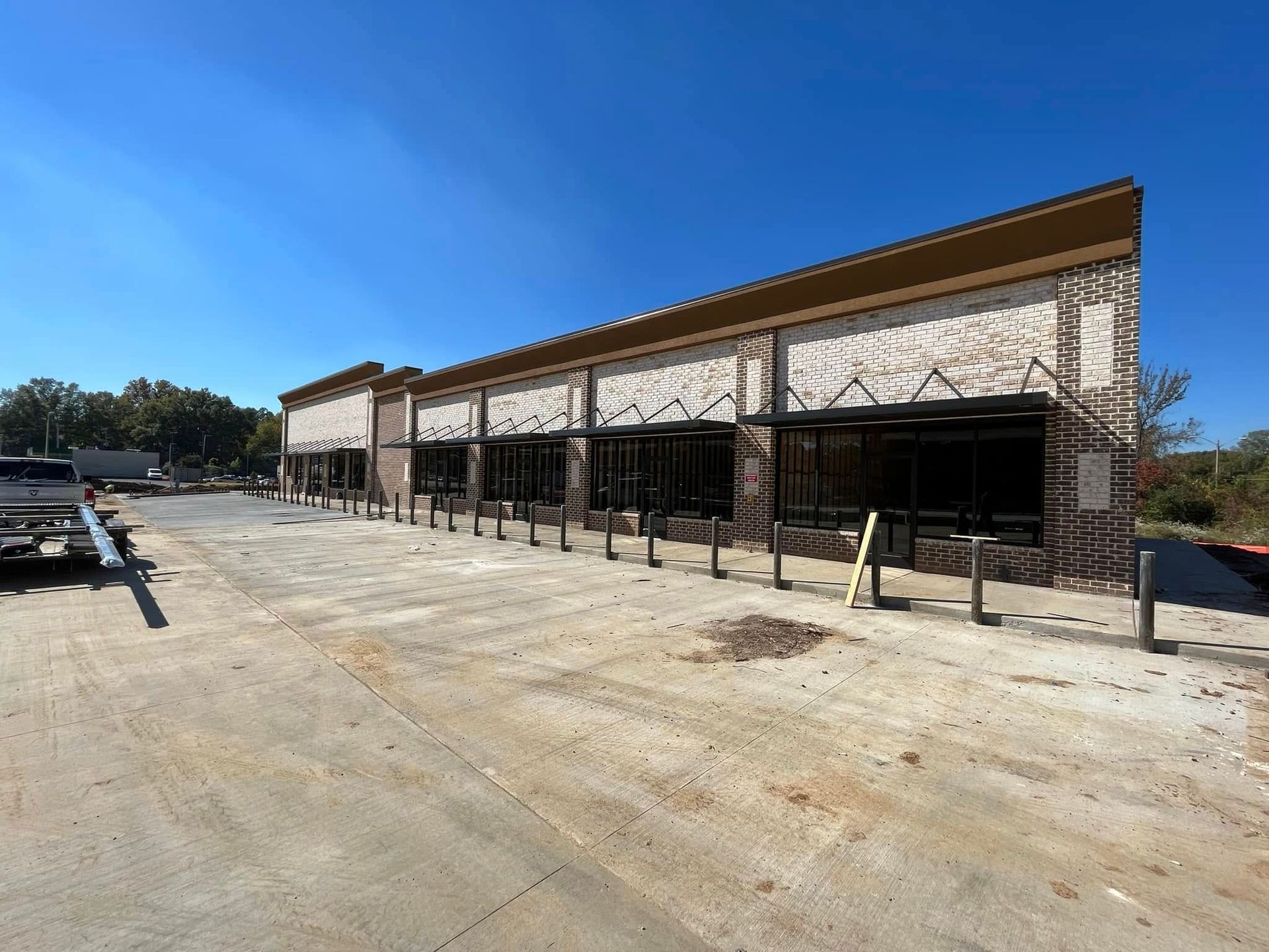 A truck is parked in front of a building under construction.
