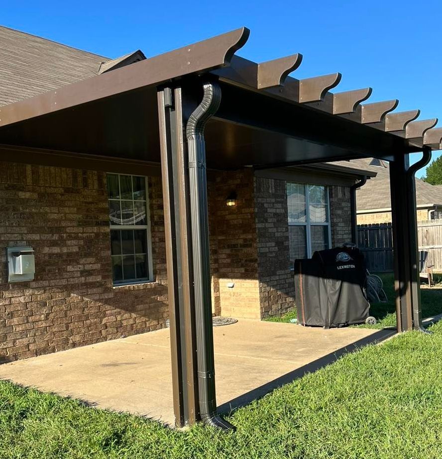 A brick house with a pergola in front of it