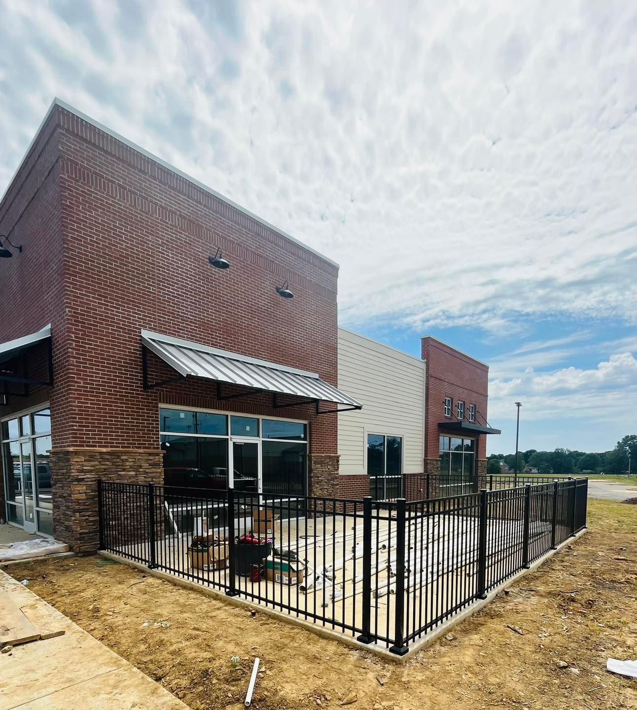A brick building with a metal fence around it