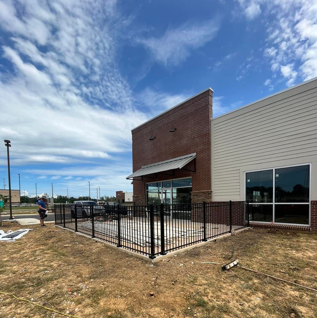 A large building with a fence around it and a lot of windows.