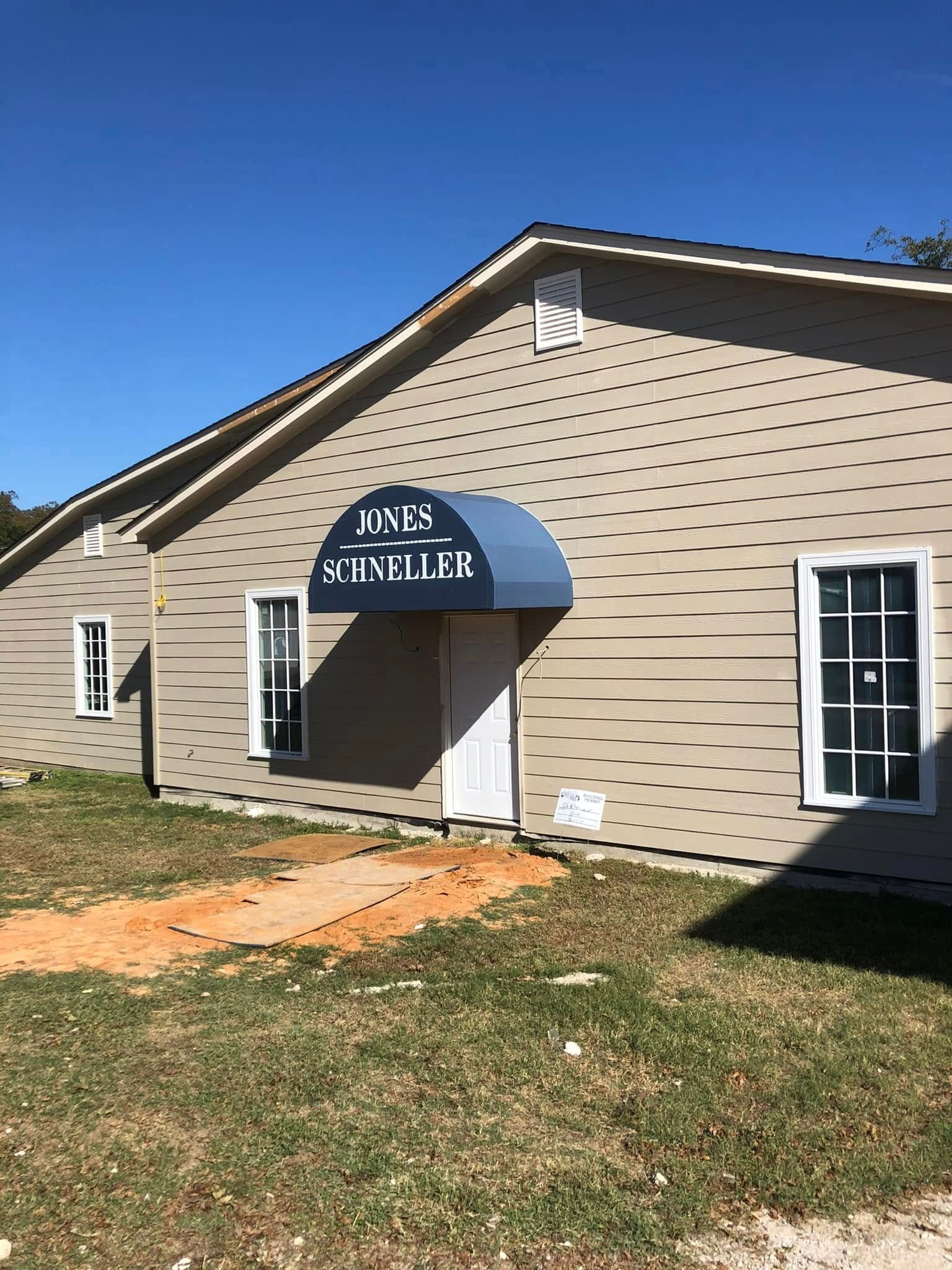 A house with a blue awning on the front of it.