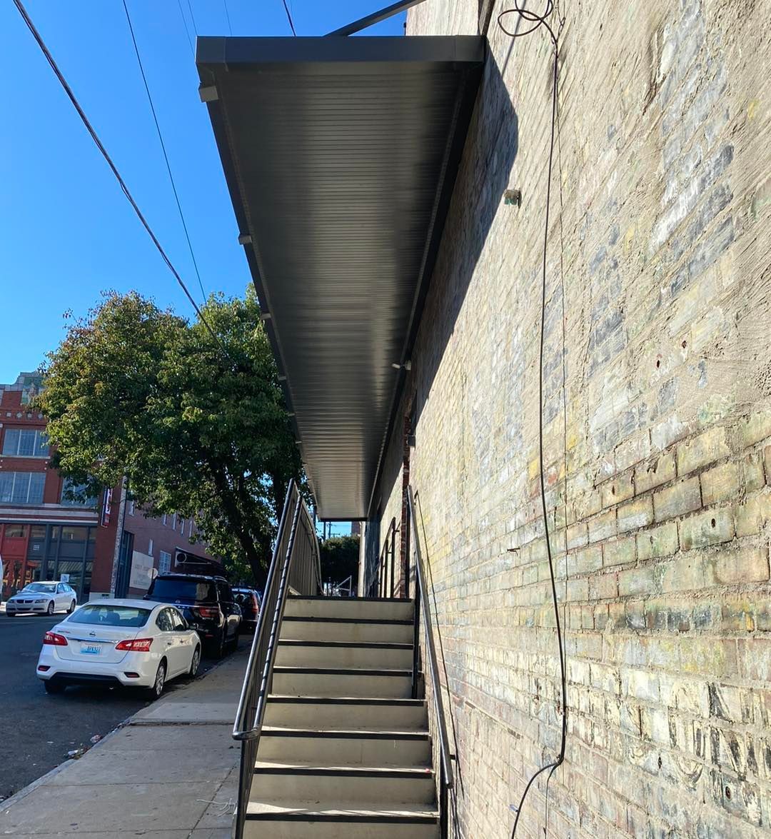 Stairs leading up to a building with a canopy over them