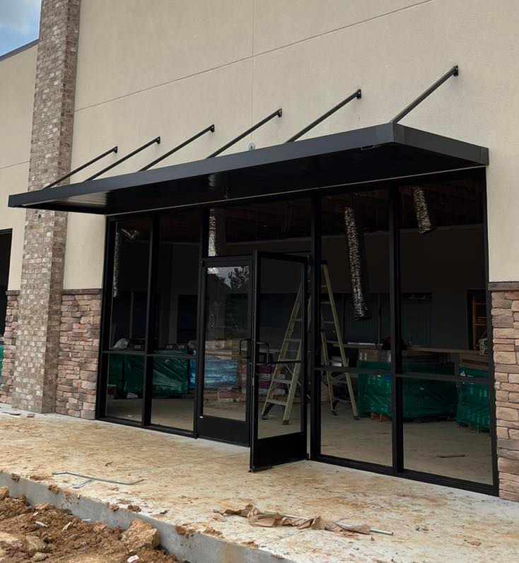 A building under construction with a canopy over the door