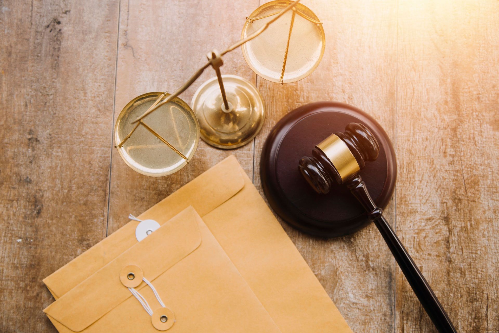 A man in handcuffs is sitting at a table talking to a lawyer