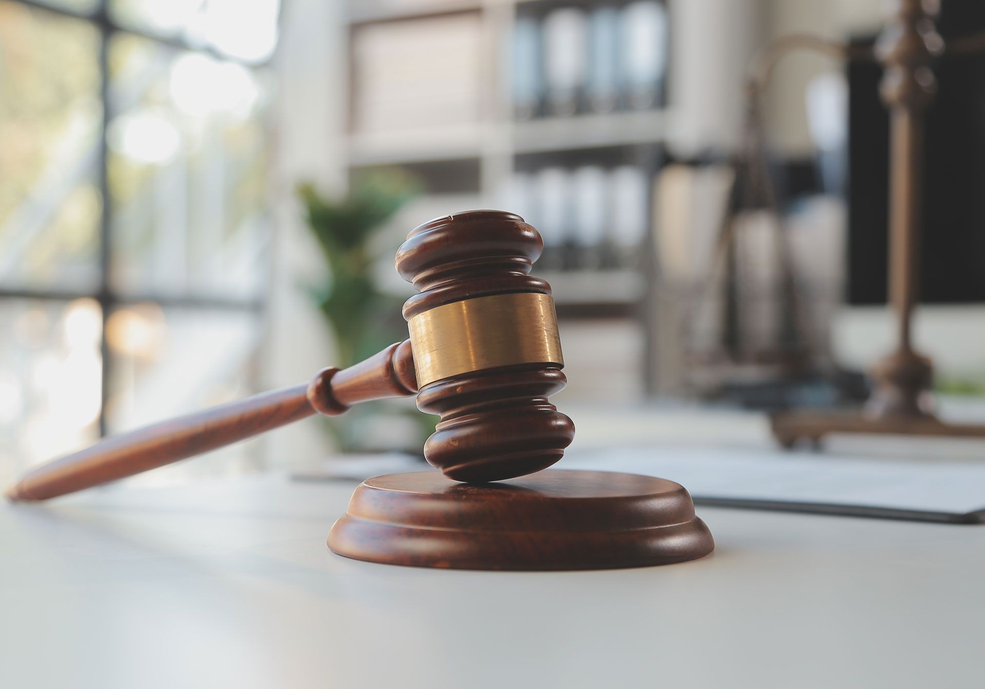 A wooden judge's gavel is sitting on a white table