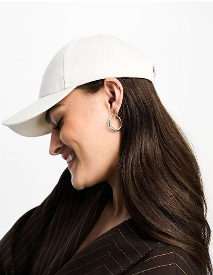 A Woman Wearing a White Baseball Cap And Hoop Earrings — Hat Embroidery in Townsville
