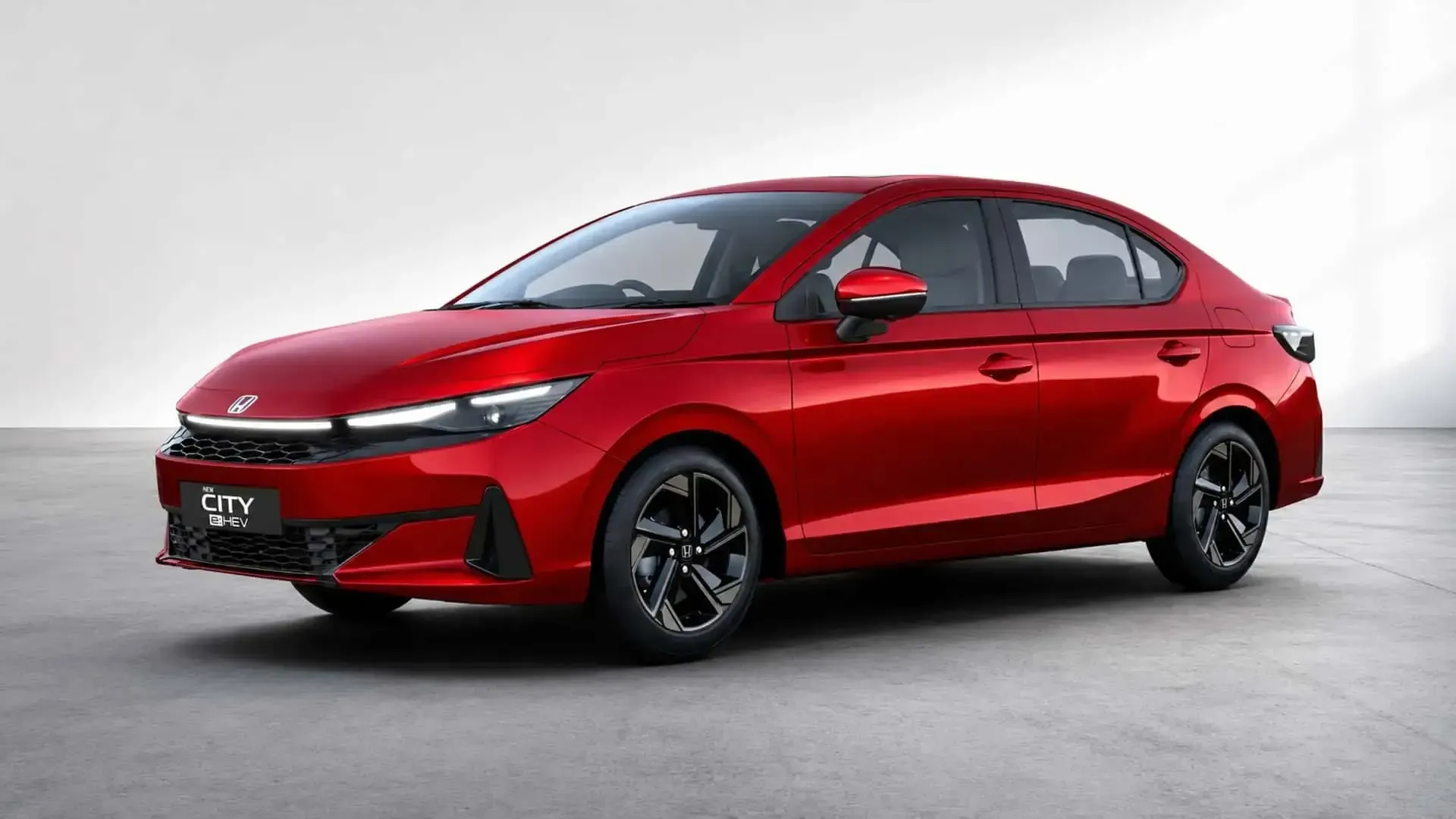Red sedan on a white studio background, shown in side front view.
