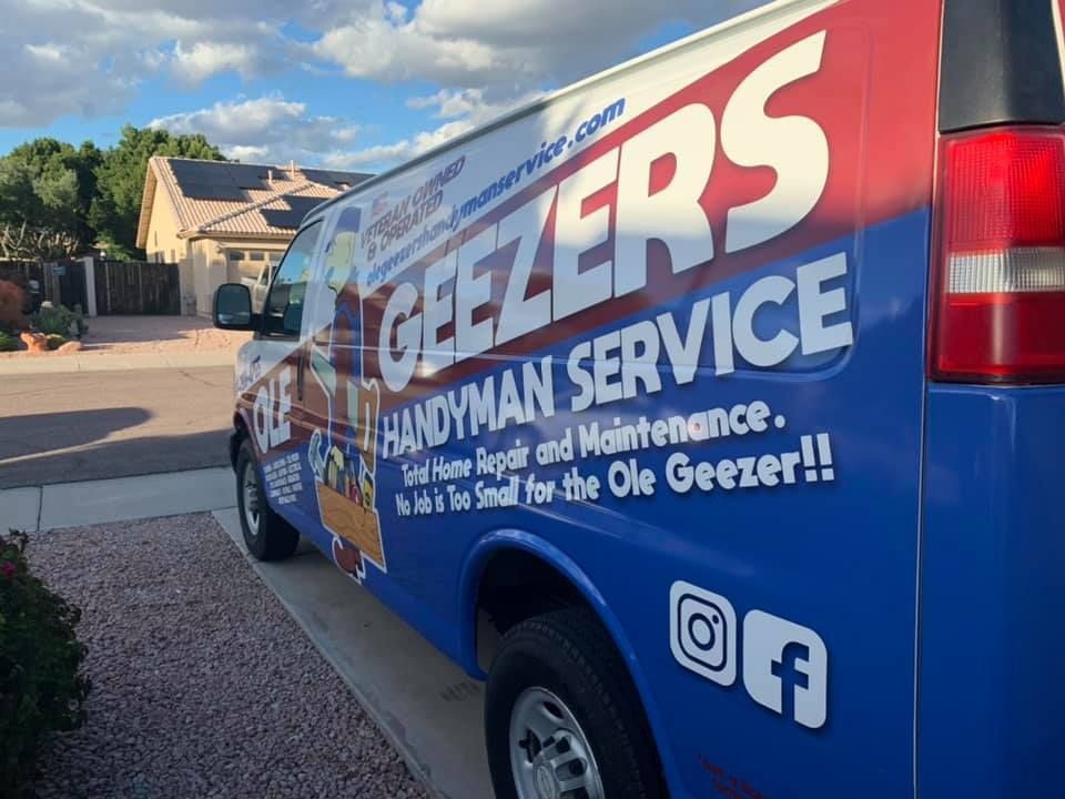 Blue, white, and red Geezers Handyman Service van parked on a driveway; text and social media logos visible.