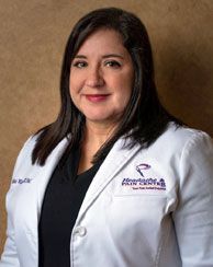 Woman in a white lab coat, smiling. 