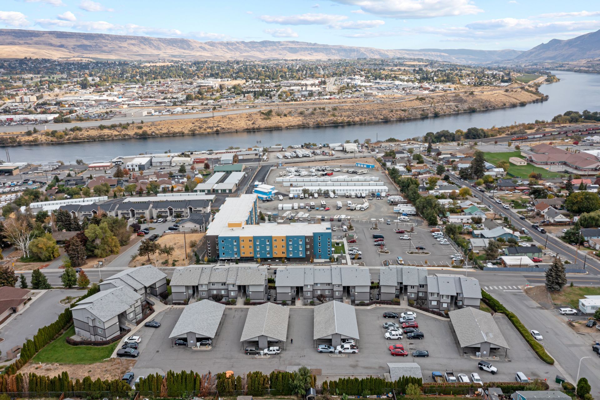 An aerial view of a city with a river in the background