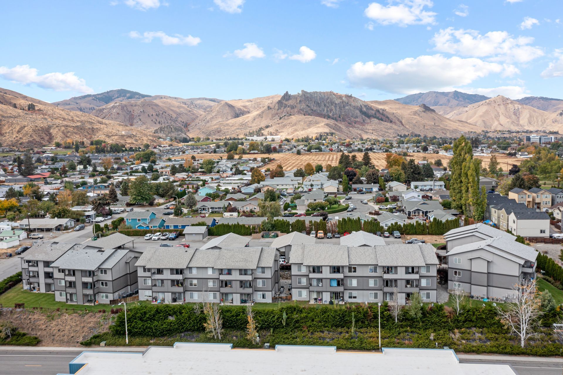 An aerial view of a city with mountains in the background.