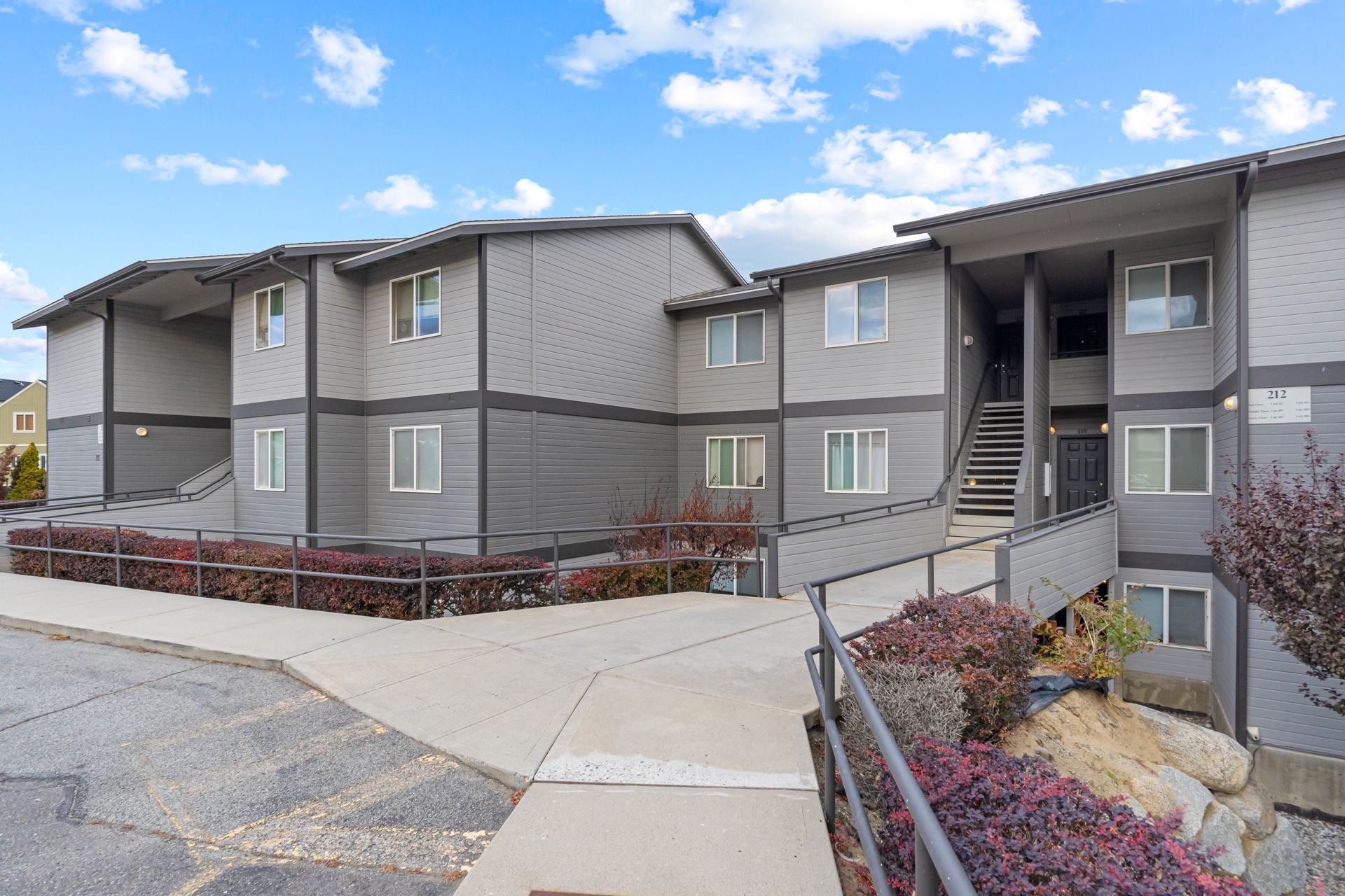 A large apartment building with stairs leading up to it.