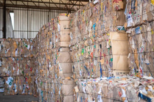 A warehouse filled with lots of cardboard boxes stacked on top of each other.