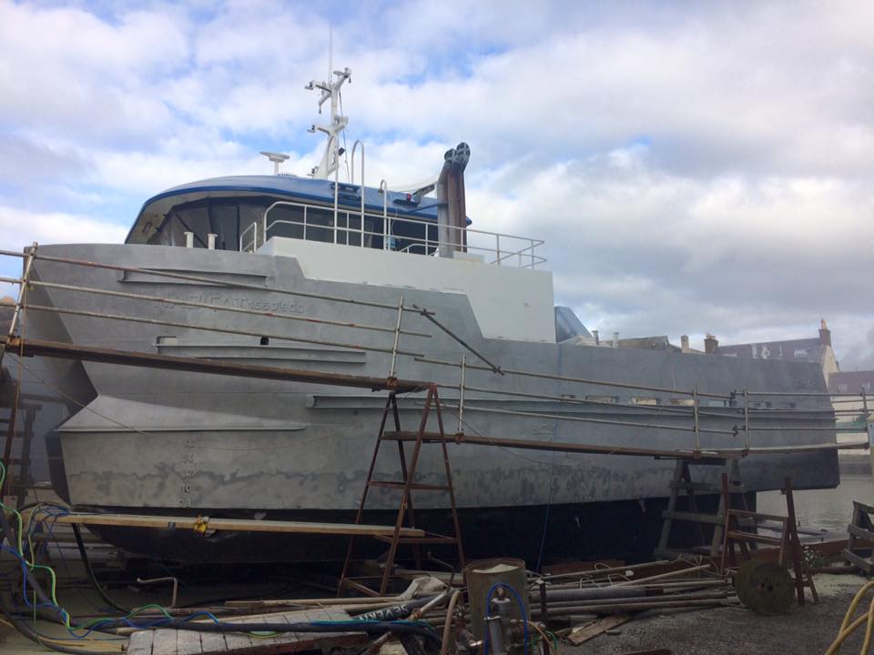 A large white boat in for refitting at A Noble & Sons yard in Girvan
