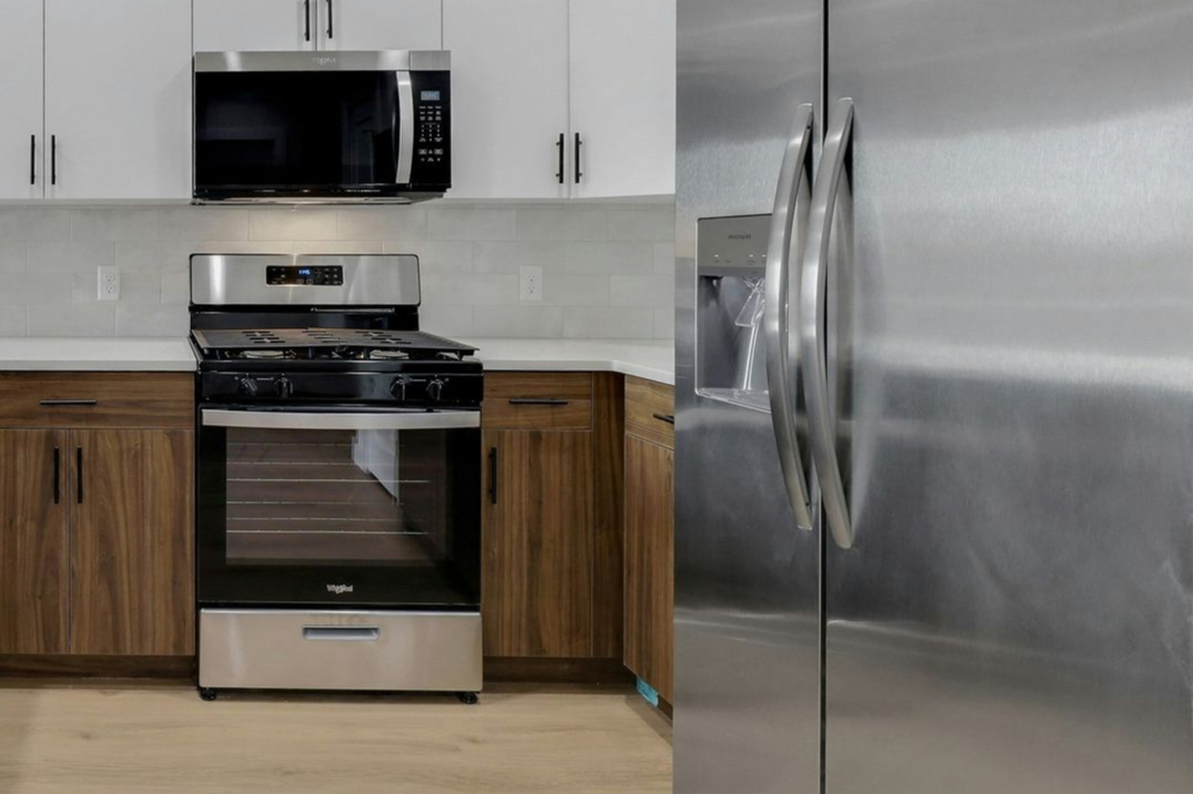 Modern kitchen with stainless steel appliances, white and brown cabinets.