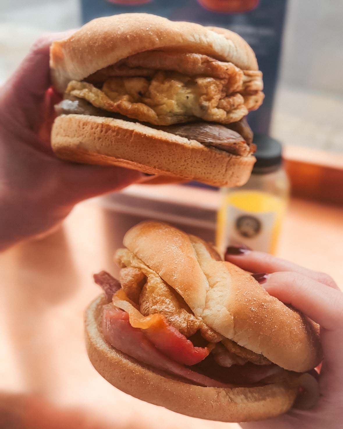 breackfast sandwiches in their hands