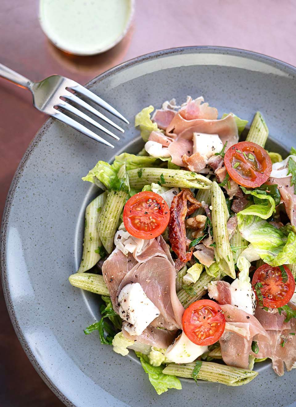 a plastic container filled with pasta and vegetables