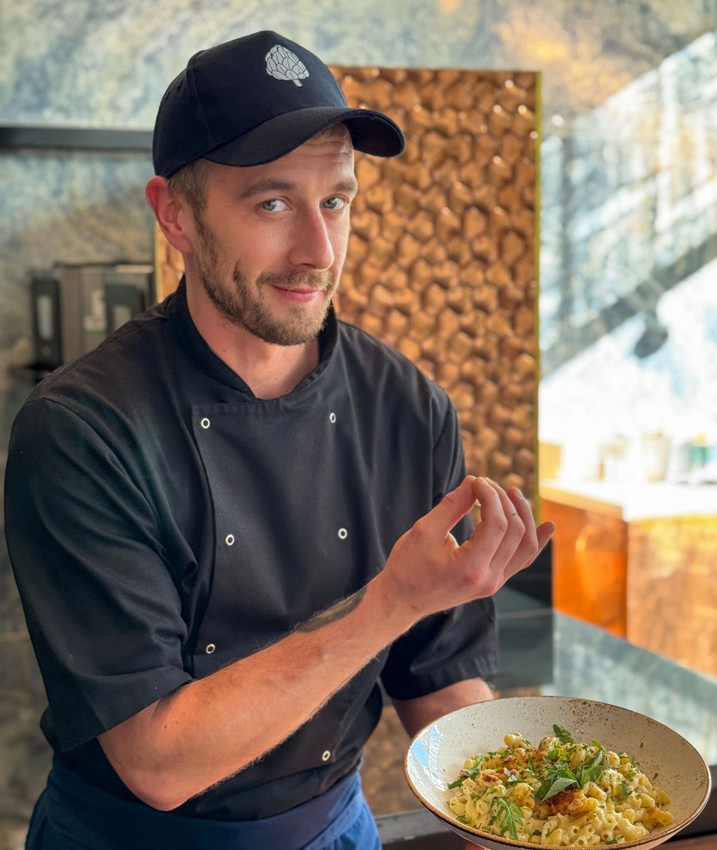 our chef holding a bowl of food
