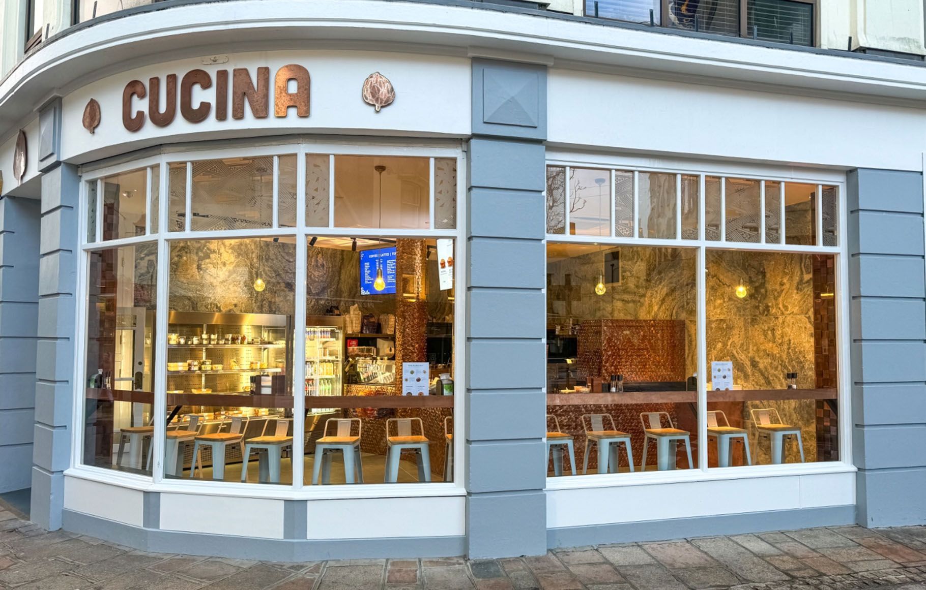 a restaurant called cucina is located on the corner of a building
