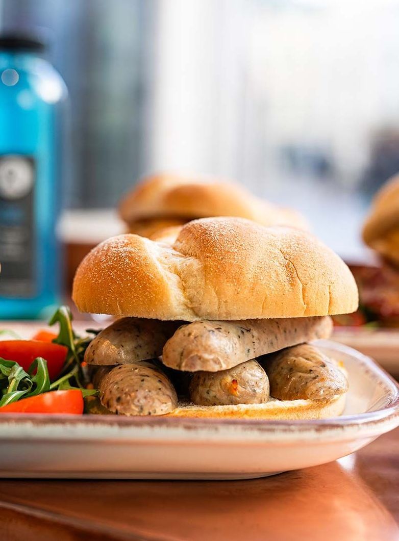 a person is holding two sandwiches in their hands