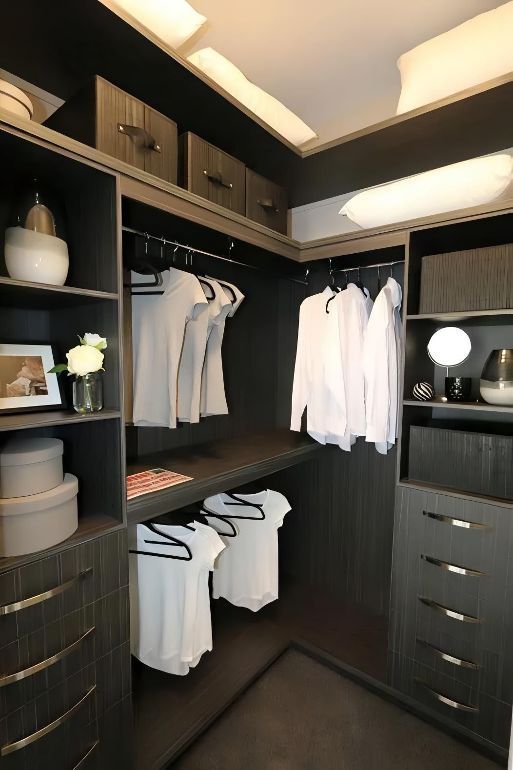 A Walk in Closet With Clothes Hanging on Racks and Shelves — Ross Joinery Kitchens In Garbutt, QLD