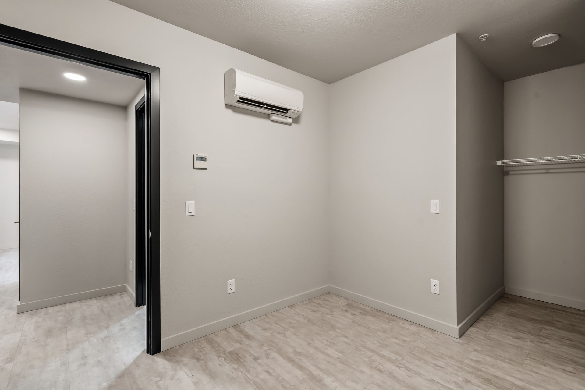 Photo of a bedroom with a walk-in closet and contemporary AC 