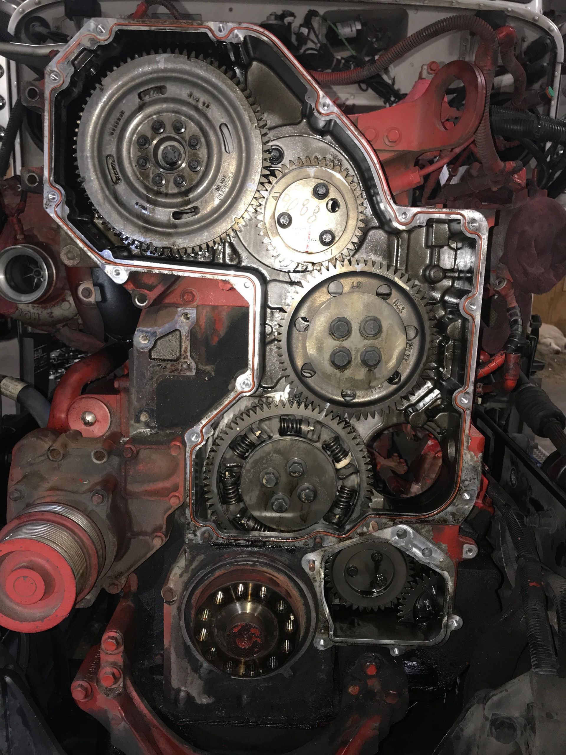 Engine components: Gears and timing chain visible inside a red engine block.