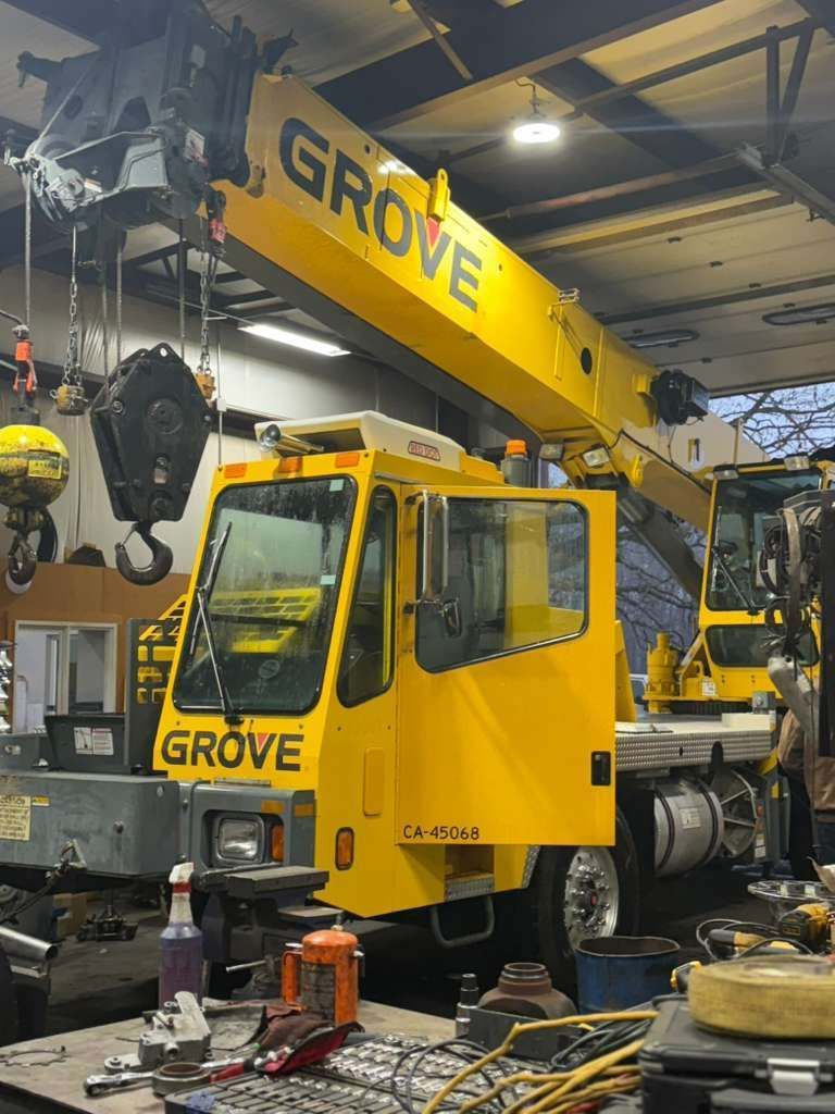 Yellow Grove crane in a workshop.