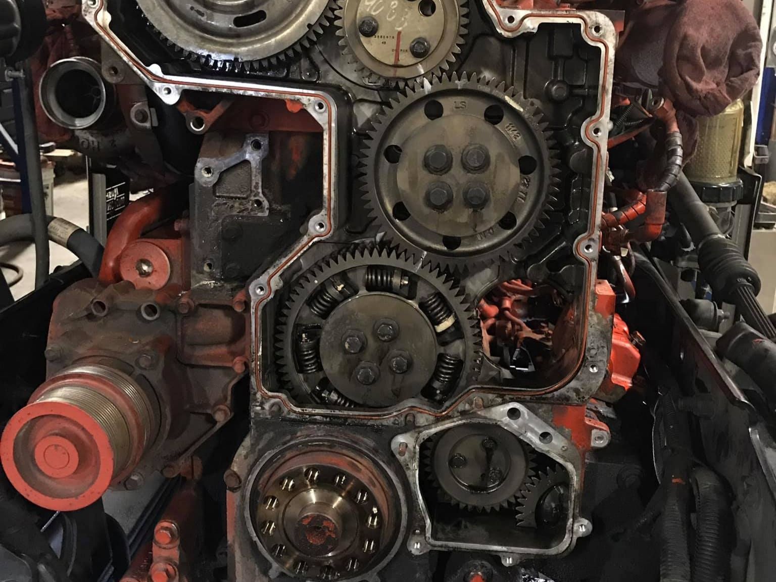 Engine gears exposed, with red accents and several visible gears of varying sizes.