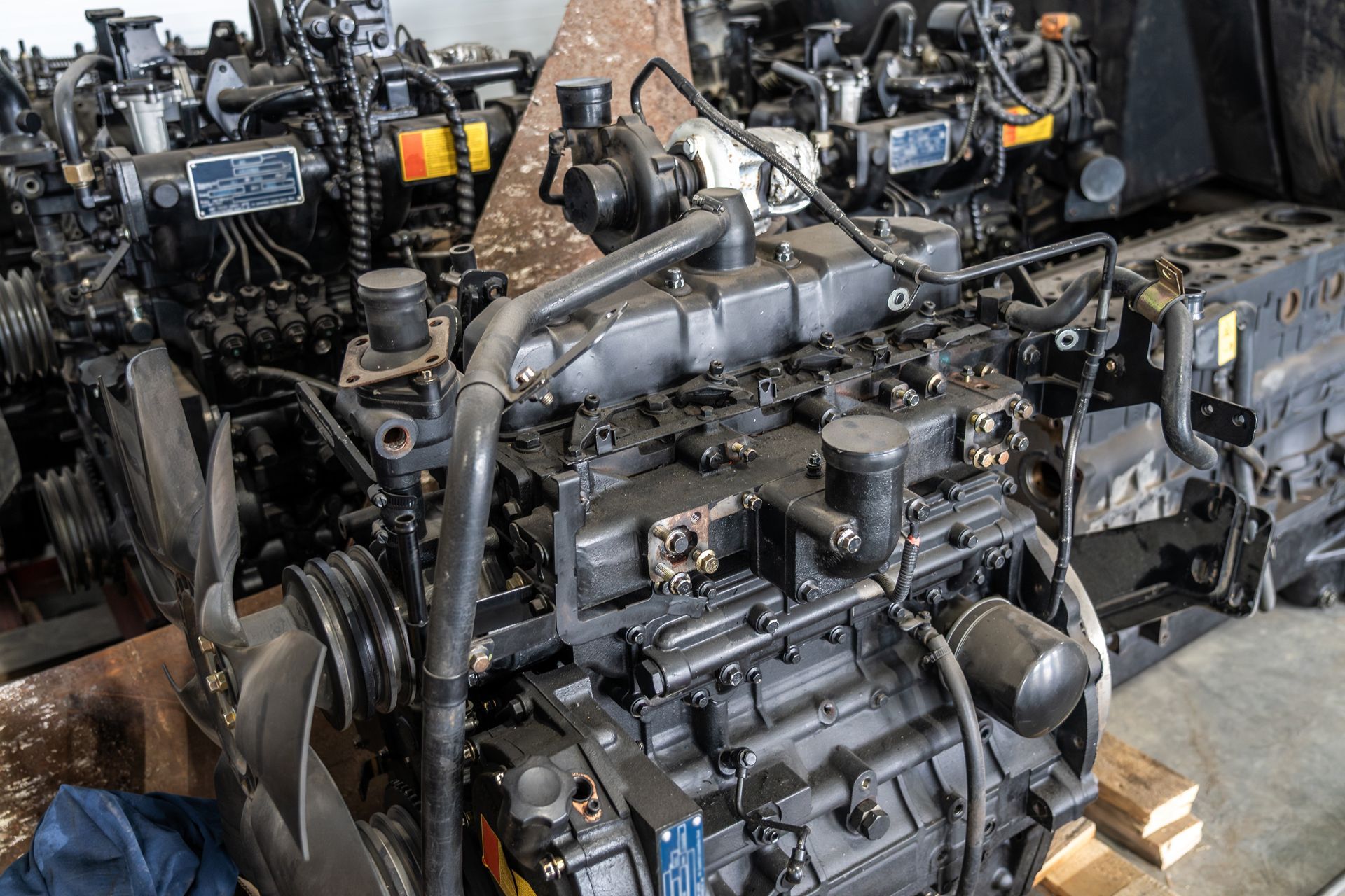 Several black diesel engines stacked together.