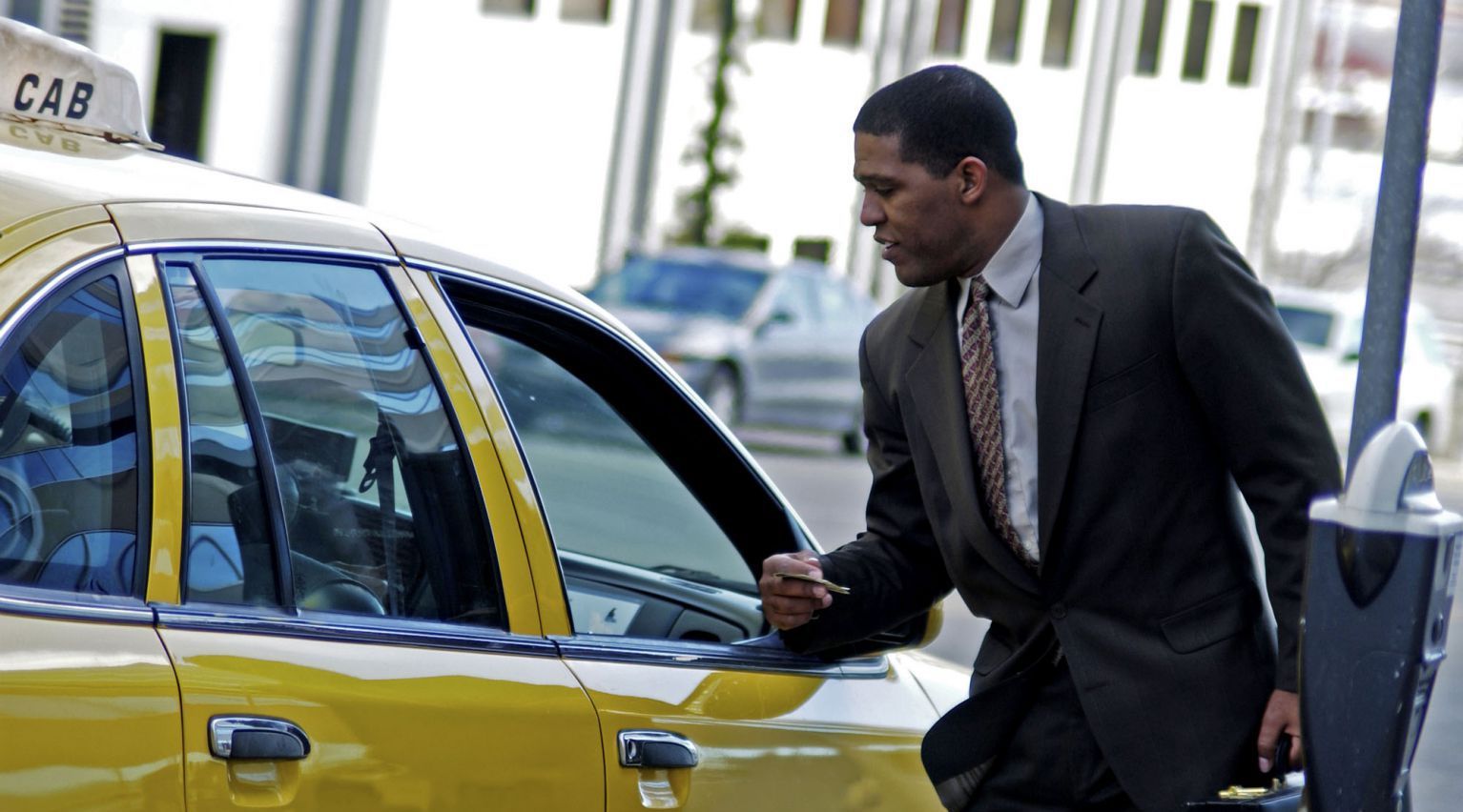 Man paying the airport taxi rate in Monroe, NY