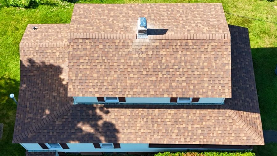 An aerial view of a house with a brown roof.
