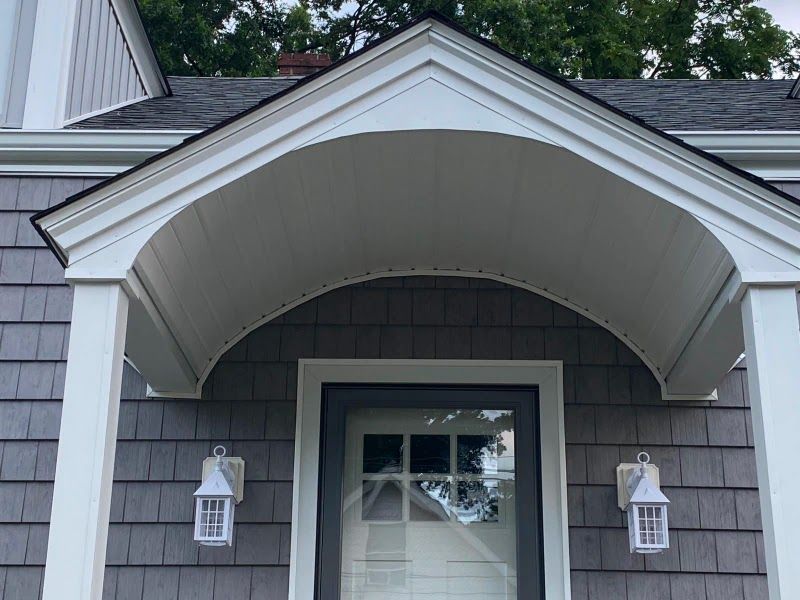 A house with a porch and a white door