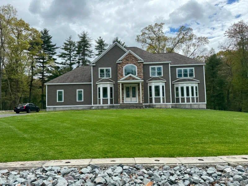 A large house with a car parked in front of it