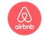 Airbnb logo: white icon and wordmark on a coral-red circle
