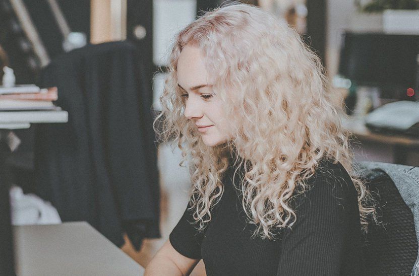 A woman at a desk using a computer
